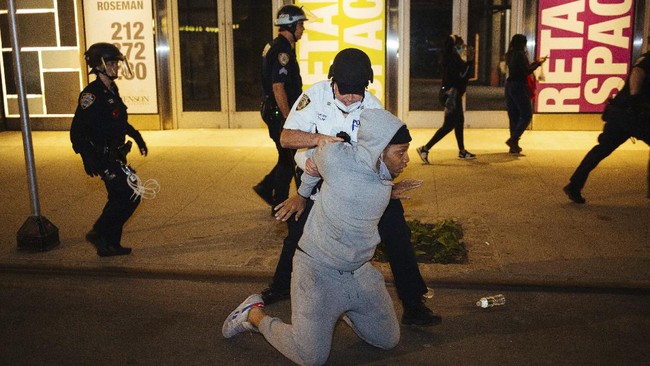 Police take a man into custody Sunday, May 31, 2020, in New York. Demonstrators took to the streets of New York City to protest the death of George Floyd, who died May 25 after he was pinned at the neck by a Minneapolis police officer. (AP Photo/Kevin Hagen).