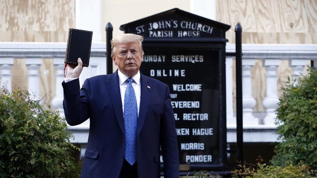 President Donald Trump holds a Bible as he visits outside St. John's Church across Lafayette Park from the White House Monday, June 1, 2020, in Washington. Part of the church was set on fire during protests on Sunday night. (AP Photo/Patrick Semansky)