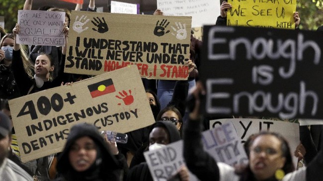 Protestors gather in Sydney, Tuesday, June 2, 2020, to support the cause of U.S. protests over the death of George Floyd and urged their own government to address racism and police violence. Floyd died last week after he was pinned to the pavement by a white police officer who put his knee on the handcuffed black man's neck until he stopped breathing. (AP Photo/Rick Rycroft)