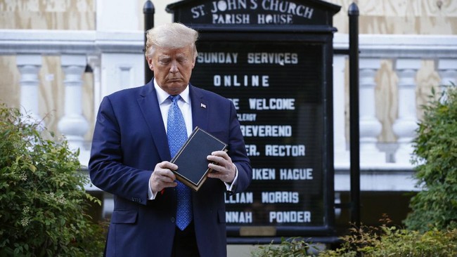 President Donald Trump holds a Bible as he visits outside St. John's Church across Lafayette Park from the White House Monday, June 1, 2020, in Washington. Part of the church was set on fire during protests on Sunday night. (AP Photo/Patrick Semansky)