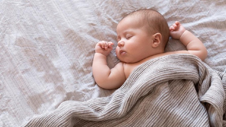 1090396236 Peaceful baby lying on a bed and sleeping at home