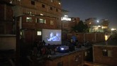 Layar Tancep, Pelipur Lara Kala Pandemi di Caracas The film Aladdin is projected on a screen set up on the roof of a home in the Petare neighborhood of Caracas, Venezuela, late Monday, June 1, 2020. A neighborhood group called The Download Zone set up the movie as a free entertainment option for families cooped up since mid-March under the COVID-19 quarantine. (AP Photo/Ariana Cubillos)