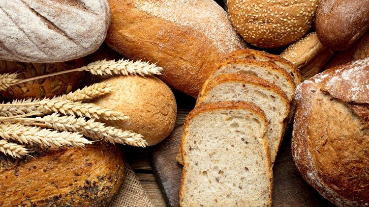 995038782 heap of various bread on wooden background