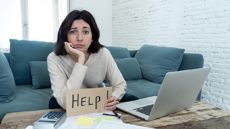 Portrait of worried young woman feeling stressed and desperate asking for help in paying bills, debts, tax expenses and accounting home finances with laptop. In online banking and financial problems.