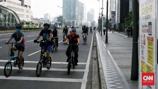 Warga memadati area car free day (CFD) di sepanjang jalan Sudirman hingga Thamrin, Jakarta Pusat meski secara resmi area tersebut belum bebas kendaraan bermotor di masa transisi Pembatasan Sosial Berskala Besar (PSBB) Jakarta, warga mayoritas  berolahraga sepeda. Minggu (7/6/2020). CNN Indonesia/Andry Novelino