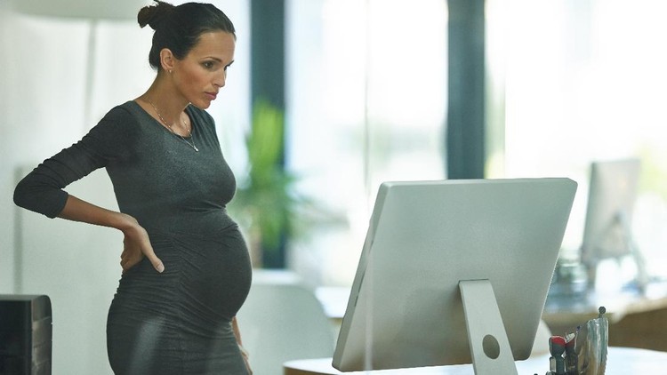 Shot of a pregnant businesswoman working in an office