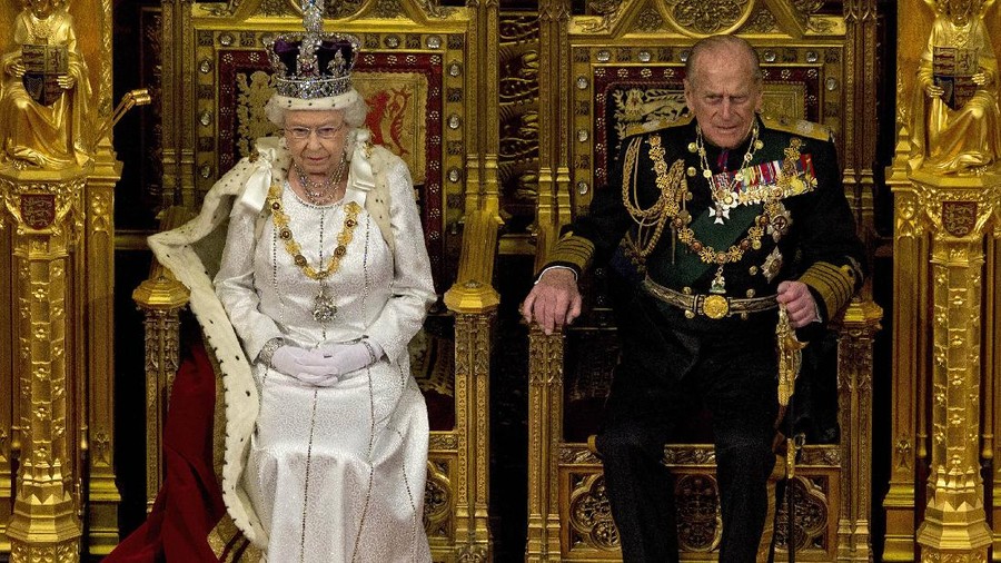 FILE - In this Wednesday, May 9, 2012 file photo, Britain's Queen Elizabeth II sits next to Prince Philip in the House of Lords as she waits to read the Queen's Speech to lawmakers in London. (AP Photo/Alastair Grant, File)