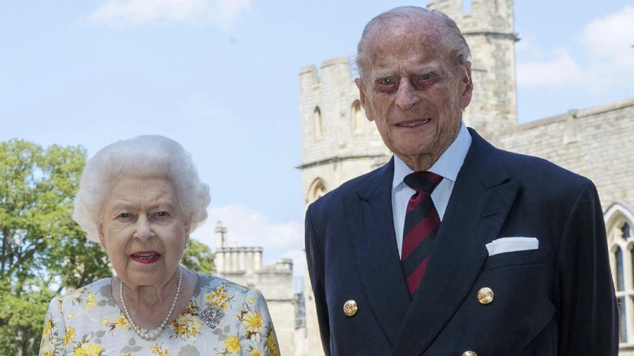 Britain's Queen Elizabeth II and Prince Philip the Duke of Edinburgh pose for a photo June 1, 2020, in the quadrangle of Windsor Castle, in Windsor, England, ahead of his 99th birthday on Wednesday, June 10. The Queen is wearing an Angela Kelly dress with the Cullinan V diamond brooch, while Prince Philip is wearing a Household Division tie. (Steve Parsons/Pool via AP)