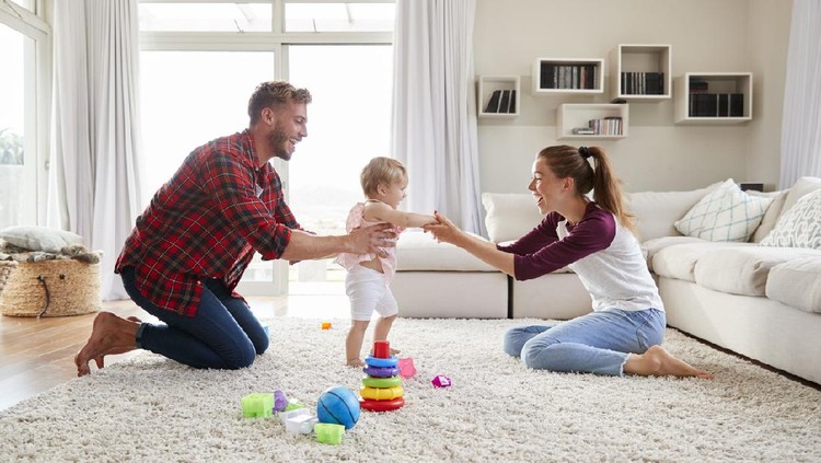 Son practice his first step with his mom. Horizontal and color photo was taken in Quebec Canada.