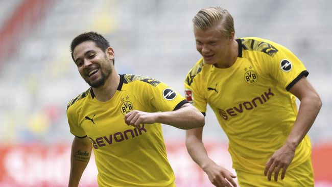 Dortmund's Raphael Guerreiro, left, and Erling Haaland react during the German Bundesliga soccer match between Fortuna Duesseldorf and Borussia Dortmund in Duesseldorf, Germany, Saturday, June 13, 2020. Because of the coronavirus outbreak all soccer matches of the German Bundesliga take place without spectators. (Bernd Thissen/Pool via AP)