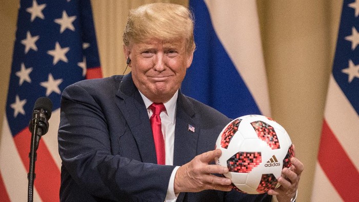 HELSINKI, FINLAND - JULY 16: President Donald Trump shows off a World Cup football given to him by Russian President Vladimir Putin during a joint press conference after their summit on July 16, 2018 in Helsinki, Finland. The two leaders met one-on-one and discussed a range of issues including the 2016 U.S Election collusion.  (Photo by Chris McGrath/Getty Images)