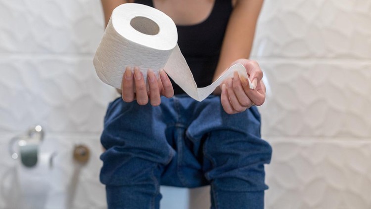 Woman sitting in the toilet