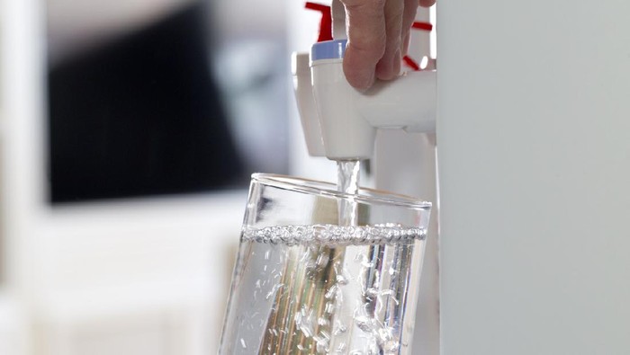 Glass being filled at a water cooler