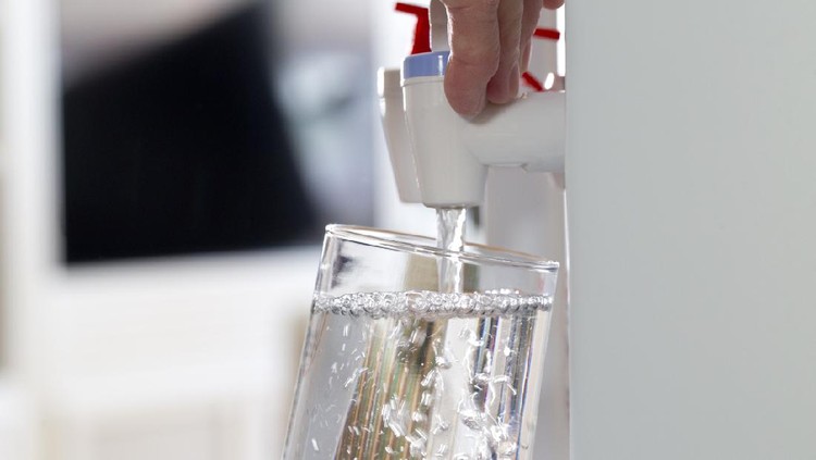 Glass being filled at a water cooler