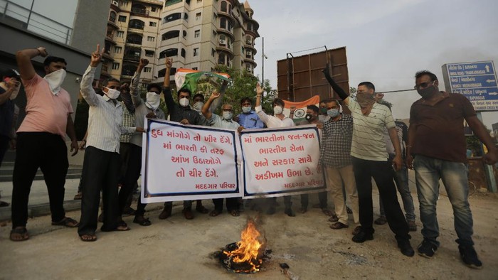 Indians shout slogans during a protest against China in Ahmedabad, India, Tuesday, June 16, 2020. At least three Indian soldiers, including a senior army officer, were killed in a confrontation with Chinese troops along their disputed border high in the Himalayas where thousands of soldiers on both sides have been facing off for over a month, the Indian army said Tuesday. (AP Photo/Ajit Solanki)