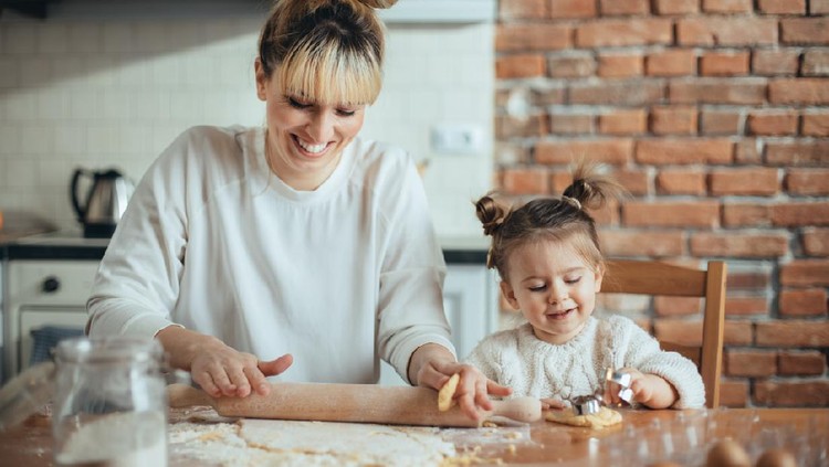 Mother and daughter baking cookies in their kitchen