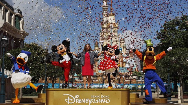 Stephanie Young, center, managing director of Hong Kong Disneyland, attends a reopening ceremony of the Hong Kong Disneyland on Thursday, June 18, 2020. Hong Kong Disneyland on Thursday opened its doors to visitors for the first time in nearly five months, at a reduced capacity and with social distancing measures in place. The theme park closed temporarily at the end of January due to the coronavirus outbreak, and is the second Disney-themed park to re-open worldwide, after Shanghai Disneyland. (AP Photo/Kin Cheung)