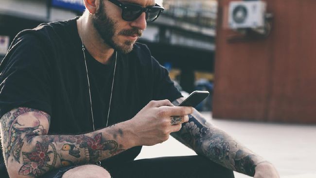 Tattooed Men Using Smartphone