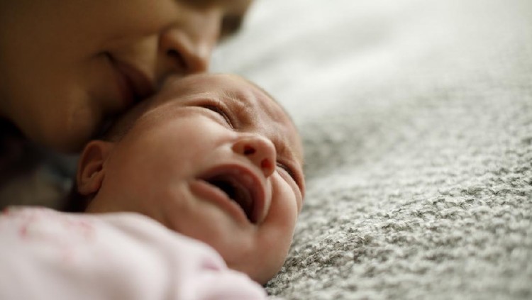 923032104 Mother calming her crying baby girl