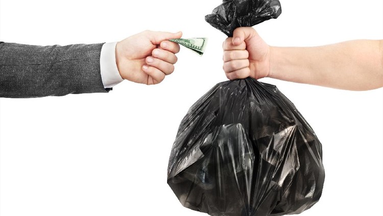 The concept of recycling. A male hand in a jacket transfers money to the other hand in exchange for a garbage bag.