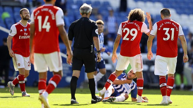 Arsenal's Matteo Guendouzi, 2nd right, gestures at Brighton's Neal Maupay, on the ground, during an argument at the end of during the English Premier League soccer match between Brighton & Hove Albion and Arsenal at the AMEX Stadium in Brighton, England, Saturday, June 20, 2020. (Richard Heathcote/Pool via AP)