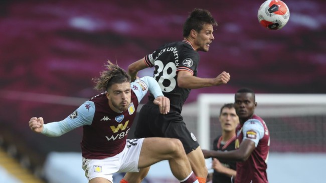 Aston Villa's Jack Grealish, left, jumps for a header with Chelsea's Cesar Azpilicueta during the English Premier League soccer match between Aston Villa and Chelsea at the Villa Park stadium in Birmingham, England, Sunday, June 21, 2020. (Molly Darlington/Pool via AP)