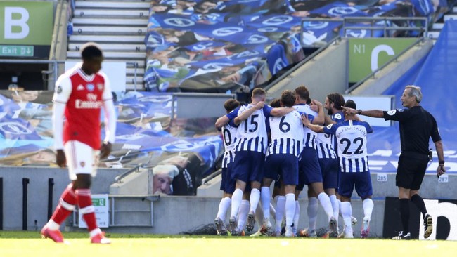 Brighton players celebrate after scoring their second goal during the English Premier League soccer match between Brighton & Hove Albion and Arsenal at the AMEX Stadium in Brighton, England, Saturday, June 20, 2020. (Gareth Fuller/Pool via AP)