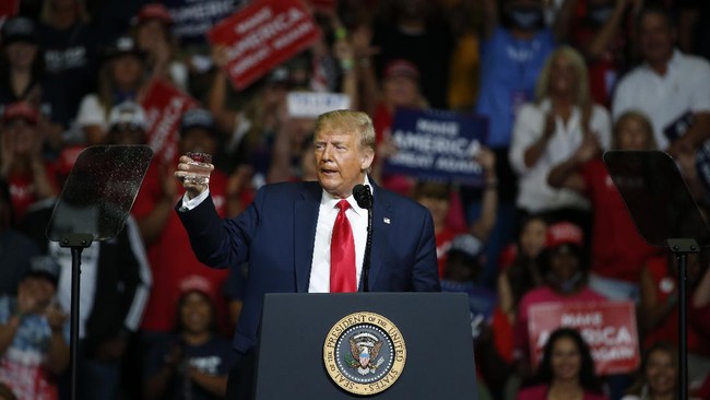 President Donald Trump holds a glass of water as he speaks during a campaign rally at the BOK Center, Saturday, June 20, 2020, in Tulsa, Okla. (AP Photo/Sue Ogrocki)