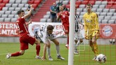 Germany Soccer Bundesliga Munich's Robert Lewandowski, left, scores the goal for the 3-1 during the German Bundesliga soccer match between Bayern Munich and SC Freiburg in Munich, Germany, Saturday, June, 20, 2020. (Sven Hoppe/dpa via AP)