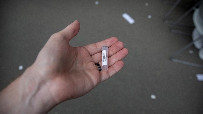 A vial for a coronavirus test is seen at a COVID-19 testing site for those who were potentially exposed to the coronavirus outbreak at a wholesale food market in Beijing, Wednesday, June 17, 2020. As the number of cases of COVID-19 in Beijing climbed in recent days following an outbreak linked to a wholesale food market, officials announced they had identified hundreds of thousands of people who needed to be tested for the coronavirus. (AP Photo/Mark Schiefelbein)