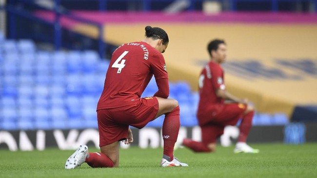 Liverpool's Virgil van Dijk takes the knee before the English Premier League soccer match between Everton and Liverpool at Goodison Park in Liverpool, England, Sunday, June 21, 2020. (Peter Powell/Pool via AP)