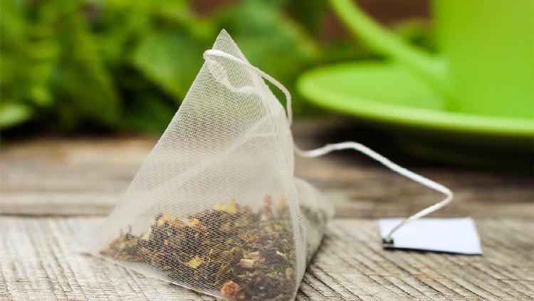 teh celup Tea bag on background of mint and and green cup
