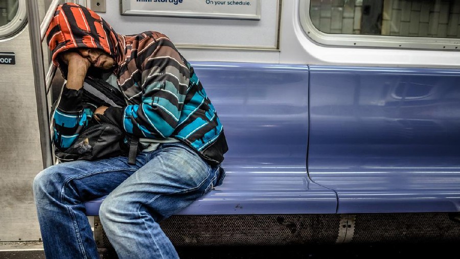 tidur ketiduran di KRL Moscow, Russia - October 29, 2019: People in the city subway. Somebody sleeping, Other using mobile phone. Travelling culture.