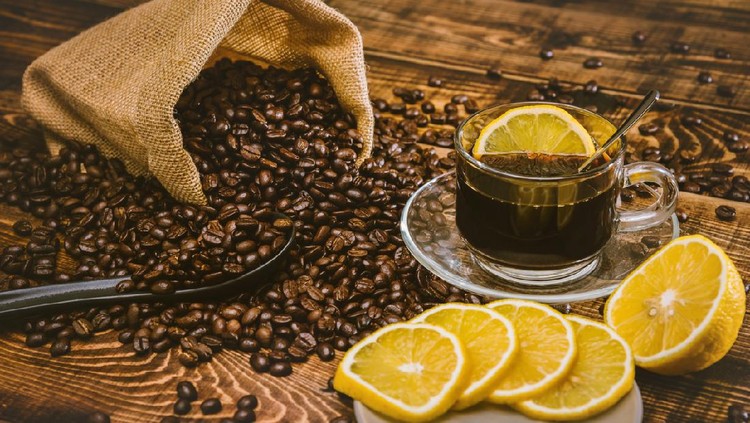 Coffee cup and beans on old kitchen table. Top view with copy space for your text. coffee bag and with sliced 