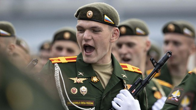 A Russian soldier sings a combat song as he marches toward Red Square to attend a dress rehearsal for the Victory Day military parade in Moscow, Russia. A massive military parade that was postponed by the coronavirus will roll through Red Square this week to celebrate the 75th anniversary of the end of World War II in Europe, even though Russia is continuing to register a steady rise in infections. (AP Photo/Alexander Zemlianichenko, File)