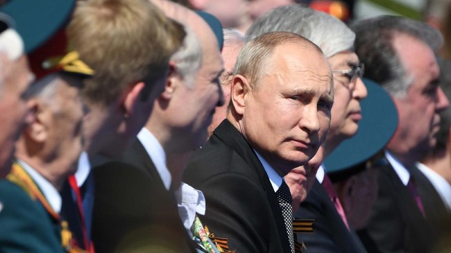 Russian President Vladimir Putin looks on during the Victory Day military parade marking the 75th anniversary of the Nazi defeat on Red Square in Moscow, Russia, Wednesday, June 24, 2020. The Victory Day parade normally is held on May 9, the nation's most important secular holiday, but this year it was postponed due to the coronavirus pandemic. (Sergey Pyatakov, Host Photo Agency via AP)