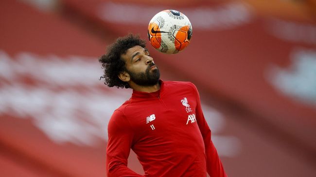 Liverpool's Mohamed Salah controls the ball as he warms-up before the English Premier League soccer match between Liverpool and Crystal Palace at Anfield Stadium in Liverpool, England, Wednesday, June 24, 2020. (Phil Noble/Pool via AP)