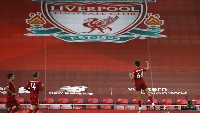 Liverpool's Trent Alexander-Arnold, right, celebrates after scoring the opening goal during the English Premier League soccer match between Liverpool and Crystal Palace at Anfield Stadium in Liverpool, England, Wednesday, June 24, 2020. (Phil Noble/Pool via AP)