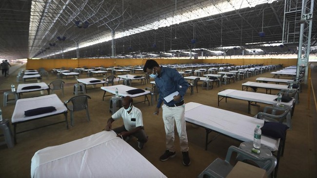 Volunteers prepare a facility that can accommodate more than ten thousand COVID-19 patients at the Radha Soami Satsang Beas complex, one off the biggest in India, in the Chattarpur area of New Delhi, India, Wednesday, June 24, 2020. New Delhi, which is among India's worst hit three states is emerging a cause of concern for the federal government and is being criticized for its poor contact tracing and a lack of enough hospital beds as India is the fourth hardest-hit country by the pandemic in the world after the U.S., Russia and Brazil. (AP Photo/Manish Swarup)
