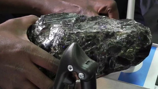 In this image made from video taken Wednesday, June 24, 2020, one of two of the biggest rough tanzanite gemstones ever found is weighed in Mererani, Tanzania Wednesday, June 24, 2020. Small-scale miner Saniniu Laizer has become an overnight millionaire after unearthing two of the biggest rough tanzanite gemstones ever found, weighing 20 pounds (9 kg) and 11 pounds (5 kg), which the government bought for preservation for $3.4 million. (AP Photo)