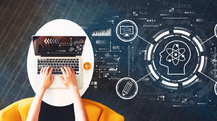 Online education concept with person using a laptop on a white table