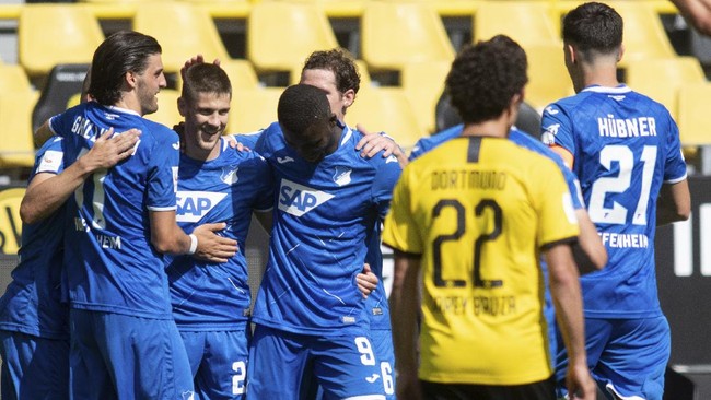 Hoffenheim's scorer Andrej Kramaric, third left, and his teammates celebrate their side's third goal during the German Bundesliga soccer match between Borussia Dortmund and 1899 Hoffenheim in Dortmund, Germany, Saturday, June 27, 2020. (Bernd Thissen/DPA via AP, Pool)