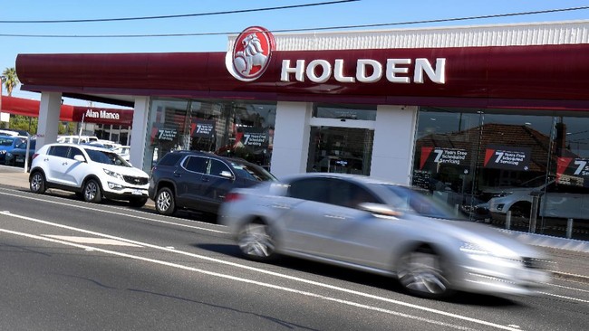 A car drives past a Holden dealership in Melbourne on February 17, 2020. - General Motors announced on February 17 it would scrap struggling Australian car brand Holden, with engineering, design and sales operations to be wound down in the coming months. (Photo by William WEST / AFP)