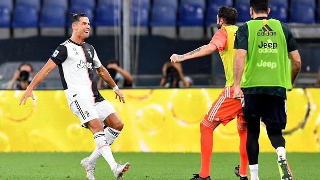 Juventus' Cristiano Ronaldo, left, celebrates after a goal during an Italian Serie A soccer match between Genoa and Juventus at the Luigi Ferraris stadium in Genoa, Italy, Tuesday, June 30, 2020. (Tano Pecoraro/LaPresse via AP)