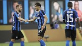 Italy Soccer Serie A Inter Milan's Antonio Candreva, center, celebrates with his teammate Christian Eriksen, left, after scoring his side's sixth goal during the Serie A soccer match between Inter Milan and Brescia at the San Siro Stadium, in Milan, Italy, Wednesday, July 1, 2020. (AP Photo/Luca Bruno)