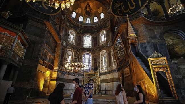 People visit the Byzantine-era Hagia Sophia, one of Istanbul's main tourist attractions in the historic Sultanahmet district of Istanbul on Thursday, June 25, 2020. The 6th-century building is now at the center of a heated debate between conservative groups who want it to be reconverted into a mosque and those who believe the World Heritage site should remain a museum. (AP Photo/Emrah Gurel)