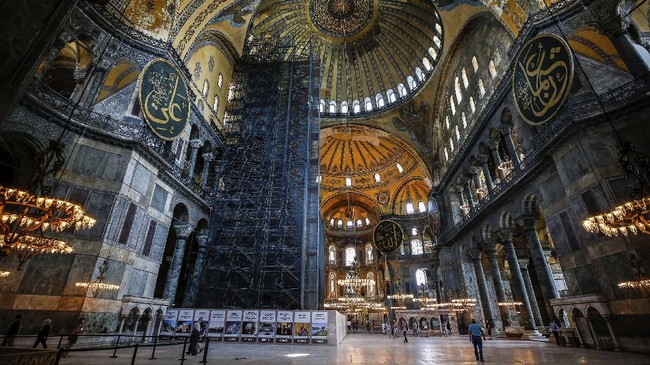 People visit the Byzantine-era Hagia Sophia, one of Istanbul's main tourist attractions in the historic Sultanahmet district of Istanbul on Thursday, June 25, 2020. The 6th-century building is now at the center of a heated debate between conservative groups who want it to be reconverted into a mosque and those who believe the World Heritage site should remain a museum. (AP Photo/Emrah Gurel)
