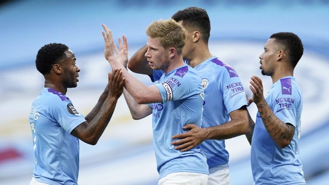 Manchester City's Kevin De Bruyne is congratulated by teammates after scoring his team's first goal during the English Premier League soccer match between Manchester City and Liverpool at Etihad Stadium in Manchester, England, Thursday, July 2, 2020. (AP Photo/Dave Thompson,Pool)