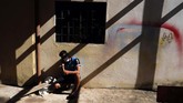 Hidup dalam Karantina Virus Corona di Paraguay A young man talks on his cellphone in the patio area of a school being used as a government-run shelter where citizens returning home are required by law to quarantine for two weeks and pass two consecutive COVID-19 tests, as a preventive measure amid the COVID-19 pandemic in Ciudad del Este, Paraguay, Wednesday, June 24, 2020. There are 15,000 Paraguayans still waiting to reenter the country in neighboring nations like Brazil and Argentina. (AP Photo/Jorge Saenz)