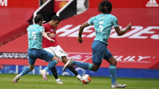 Manchester United's Mason Greenwood shoots before scoring a goal during the English Premier League soccer match between Manchester United and Bournemouth at Old Trafford stadium in Manchester, England, Saturday, July 4, 2020. (Dave Thompson/Pool via AP)